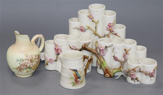 A Royal Worcester cluster of vases, applied with blossoming hawthorn, 24cms, and two Royal Worcester jugs (3)